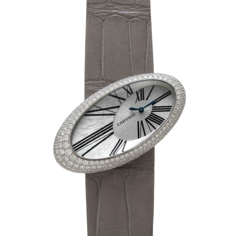 A Cartier Libre Hypnose watch with a diamond bezel, Roman numerals, and a grey leather strap.