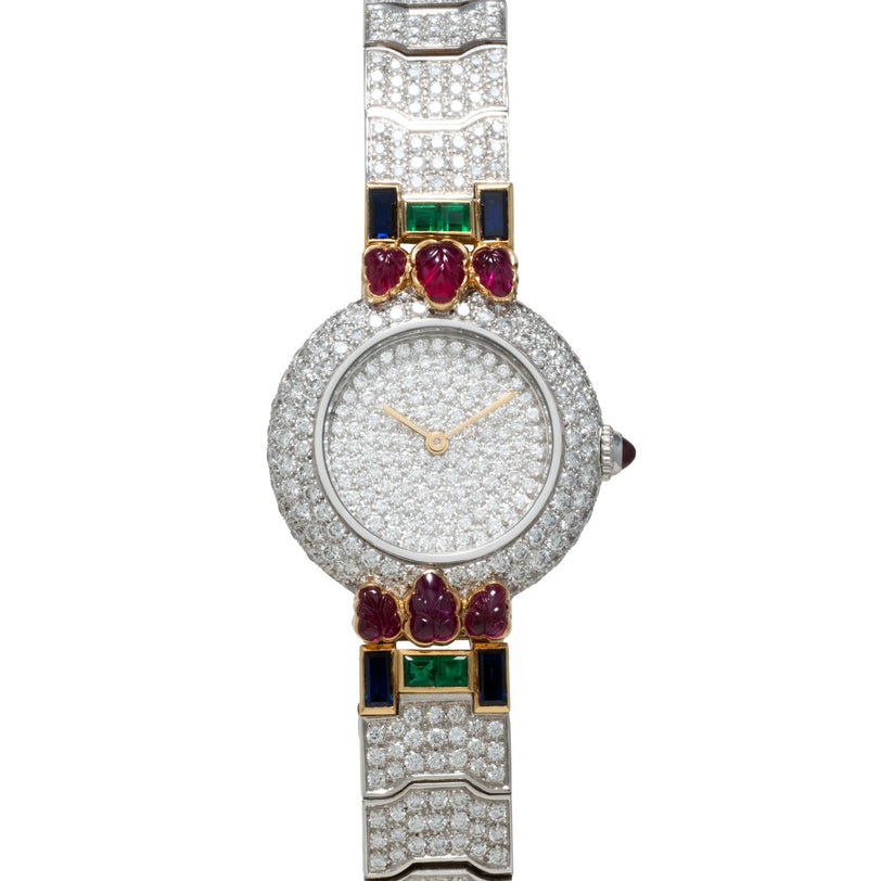 The Cartier Colisee Tutti Frutti Diamond features a diamond-encrusted bezel with colorful square and leaf-shaped gemstones and gold hands.