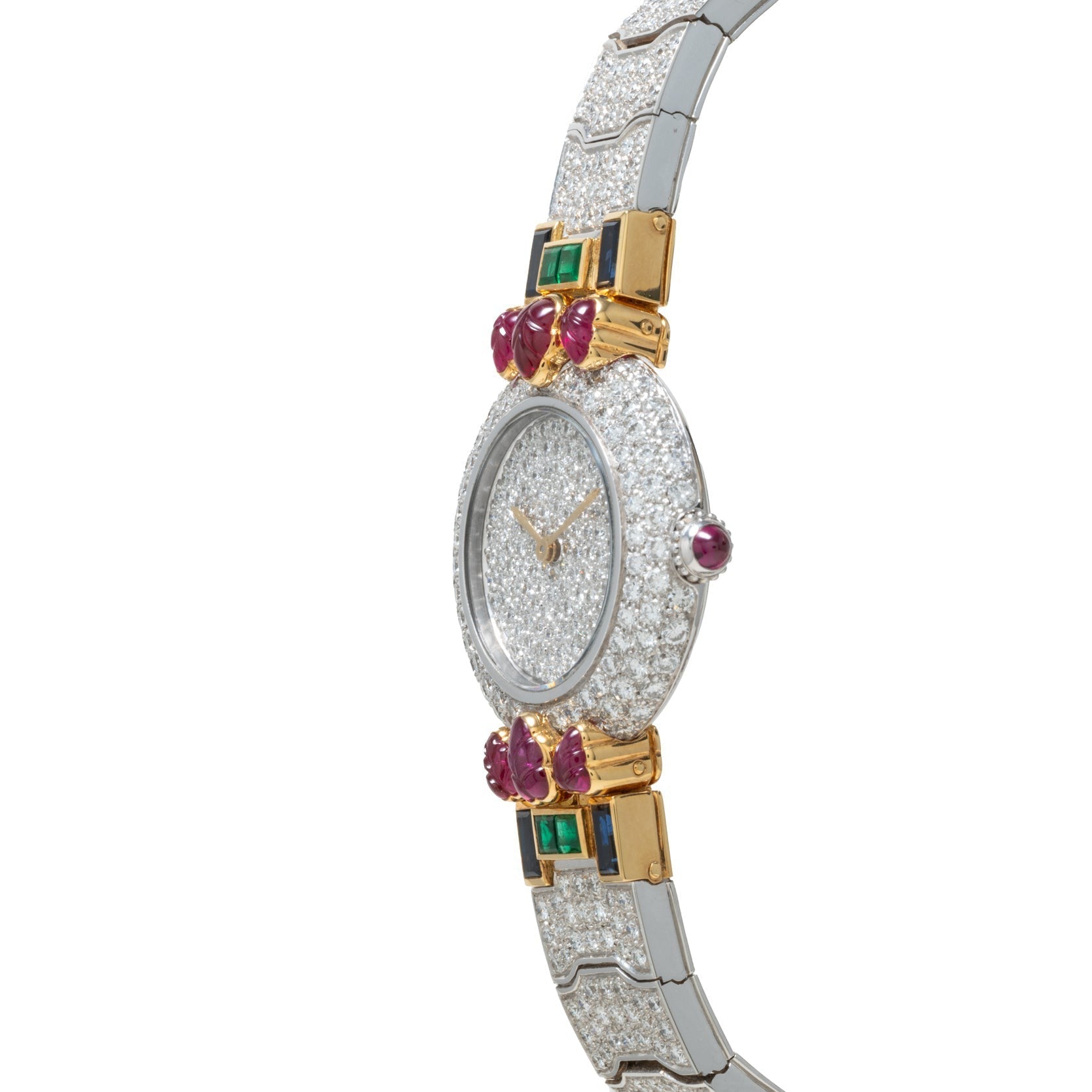 The Cartier Colisee Tutti Frutti Diamond is a luxury watch featuring a diamond-encrusted face, gold accents, green gems, and red oval stones on the band.