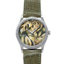 The Patek Philippe Calatrava Cloisonné Tropical Leaves II is a silver watch with a green leather strap and a leafy plant design on its face.