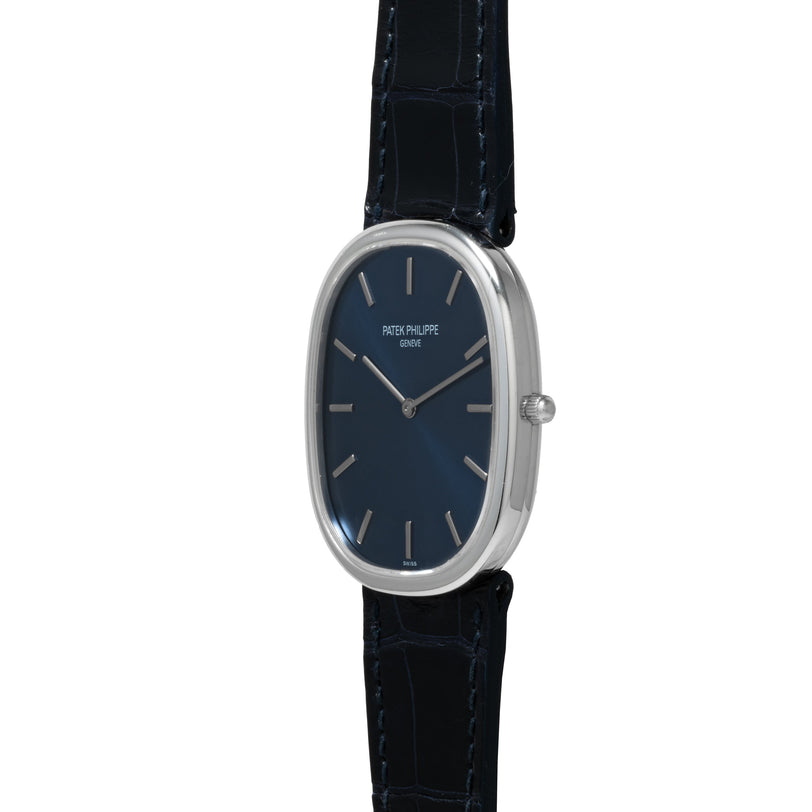 The Patek Philippe Ellipse Jumbo features a blue dial, silver case, and black leather strap, shown from a side angle.