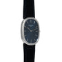 A Patek Philippe Ellipse Jumbo watch featuring a blue oval face, silver markers, and a black leather strap.
