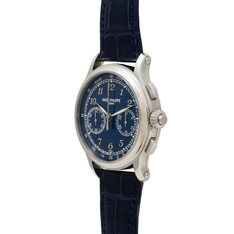 The Patek Philippe Split-Seconds Chronograph is a luxury wristwatch featuring a blue dial, dark blue leather strap, and silver casing.