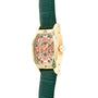 The Cartier Tortue XL Turtle Limited Edition features a gold case, green leather strap, and geometric patterned face, displayed from a side angle.