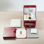 A Cartier Tortue XL Turtle Limited Edition watch in a red box, with documents, booklet, and outer case neatly arranged on a table.