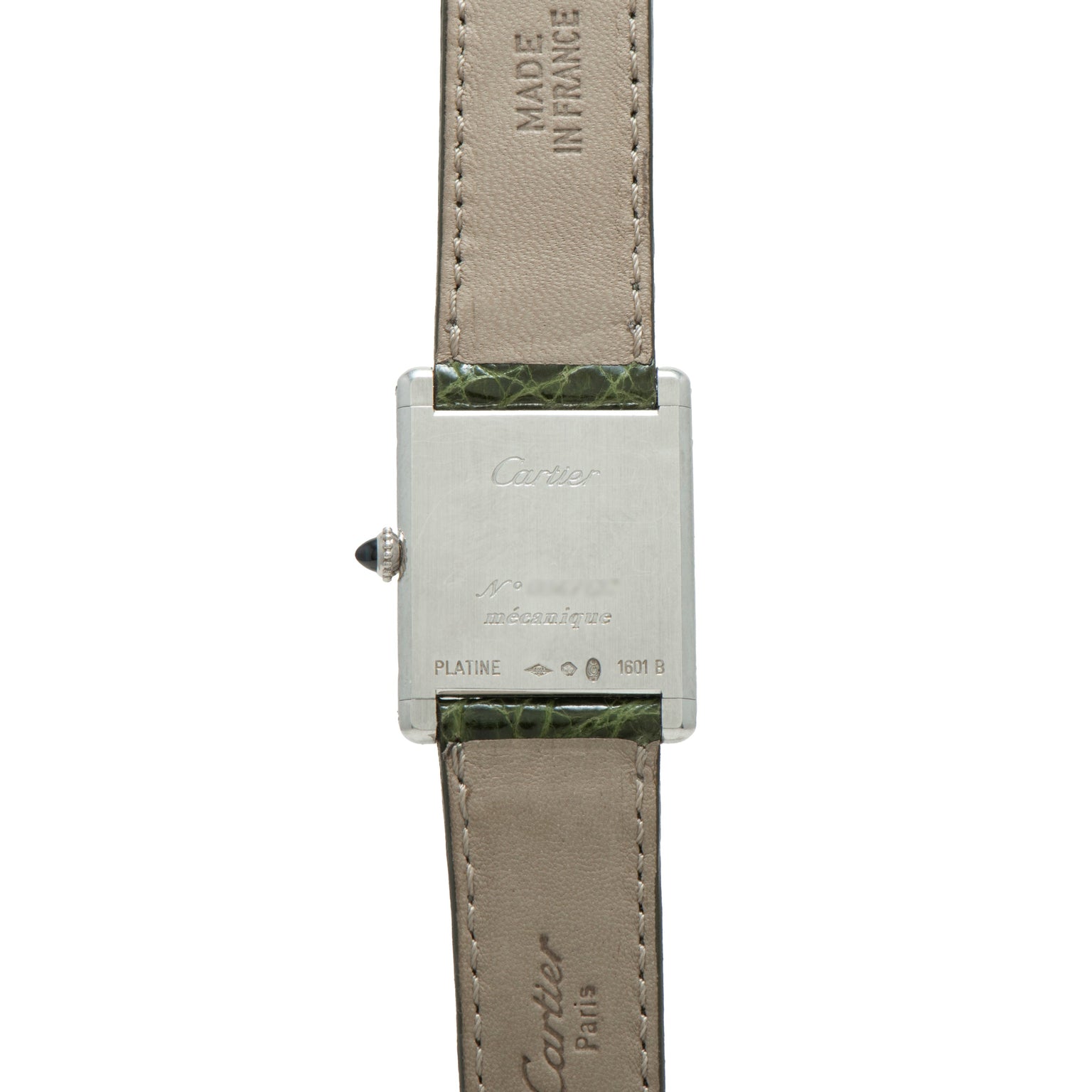 Back of a Cartier Tank Louis CPCP wristwatch with inscriptions, leather strap, and Made in France text.