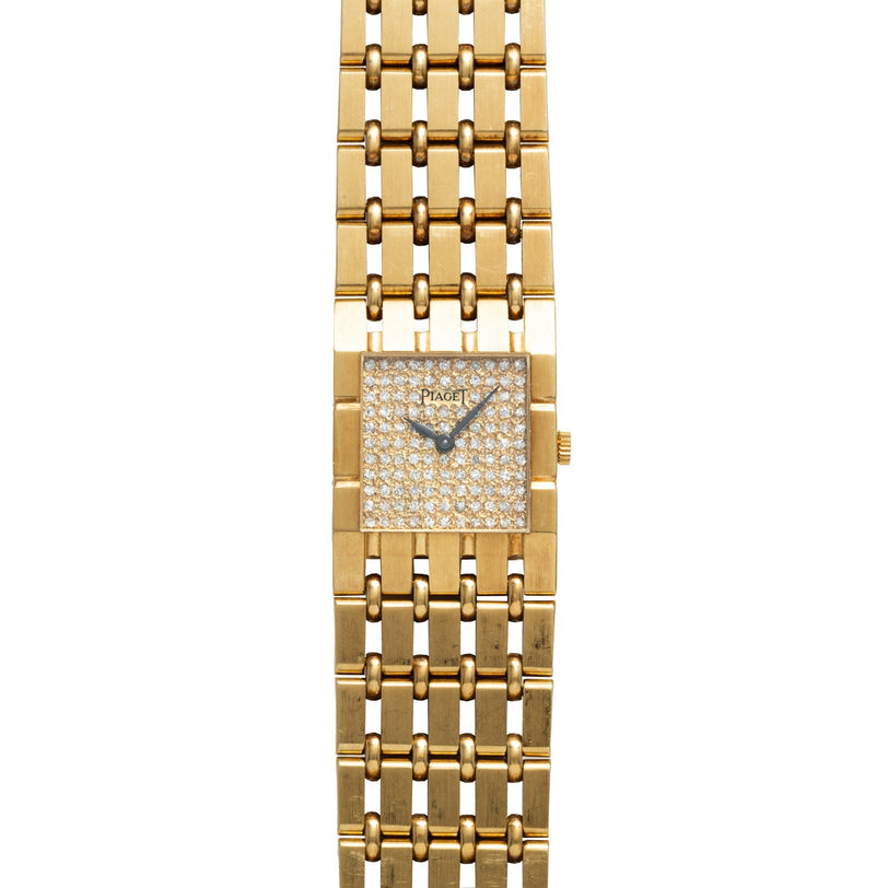 The Piaget Dancer wristwatch features a rectangular, diamond-encrusted face and a linked gold bracelet.