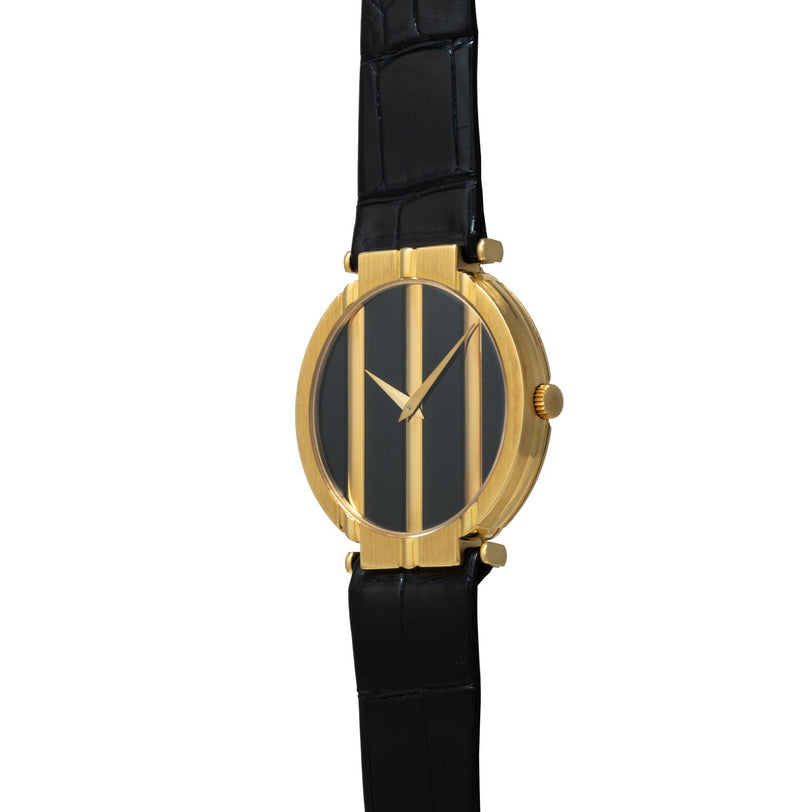 The Piaget Polo Onyx is a gold wristwatch with a black face featuring vertical gold bars and a black leather strap.