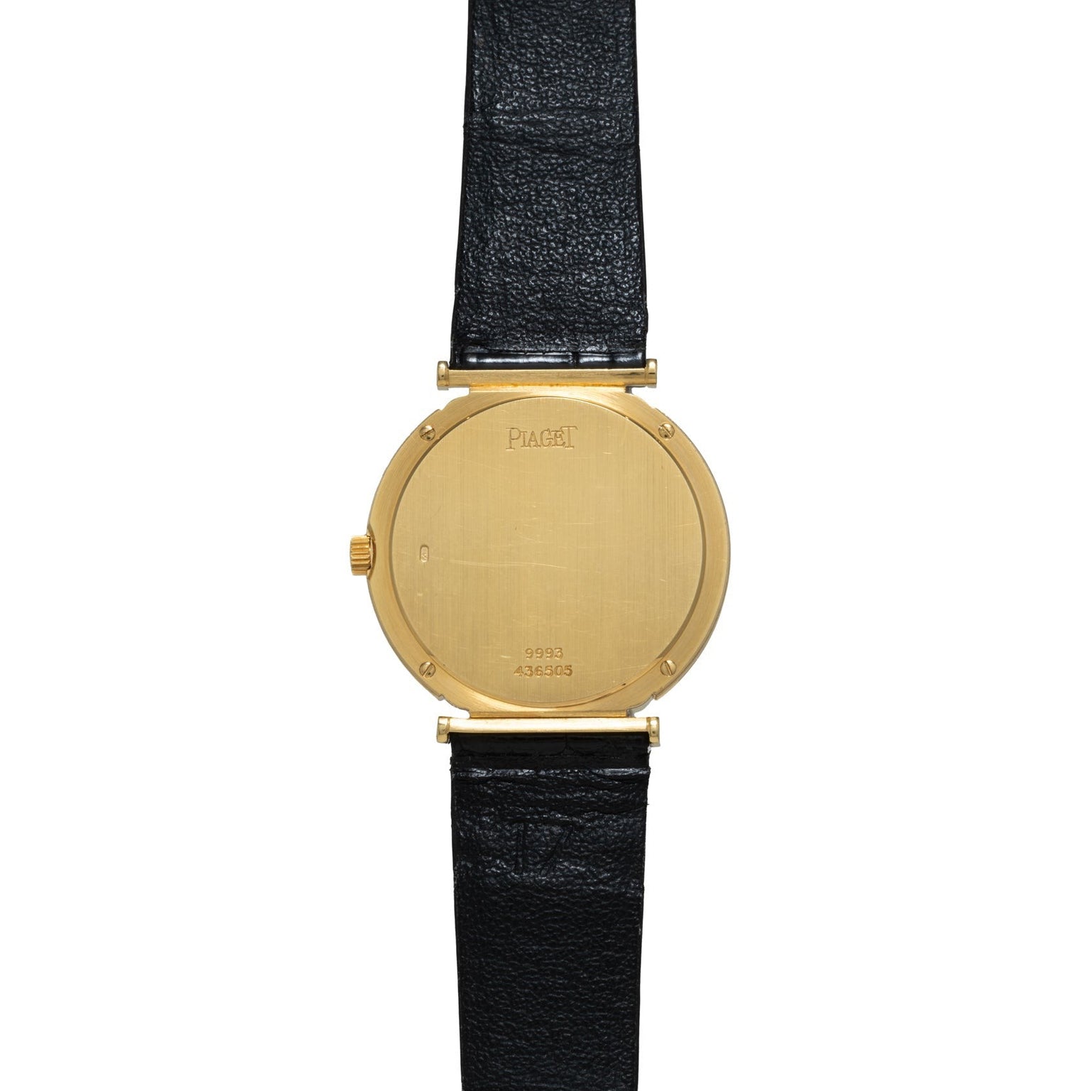 Piaget Polo Onyx gold watch with a black leather strap, displayed from the back showing visible serial numbers.