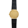 Piaget Polo Onyx gold watch with a black leather strap, displayed from the back showing visible serial numbers.