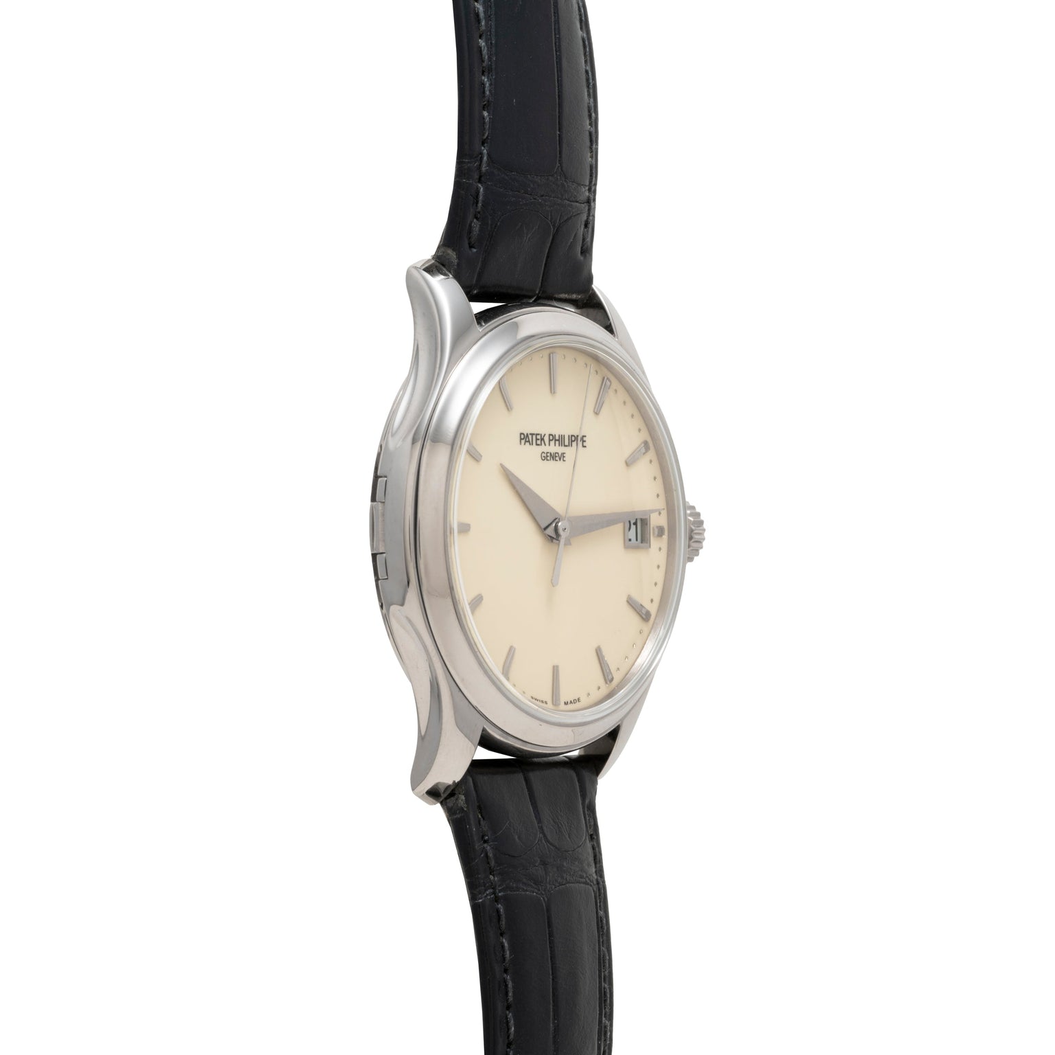 Side view of a Patek Philippe Calatrava wristwatch featuring a silver case, cream dial, and black leather strap.