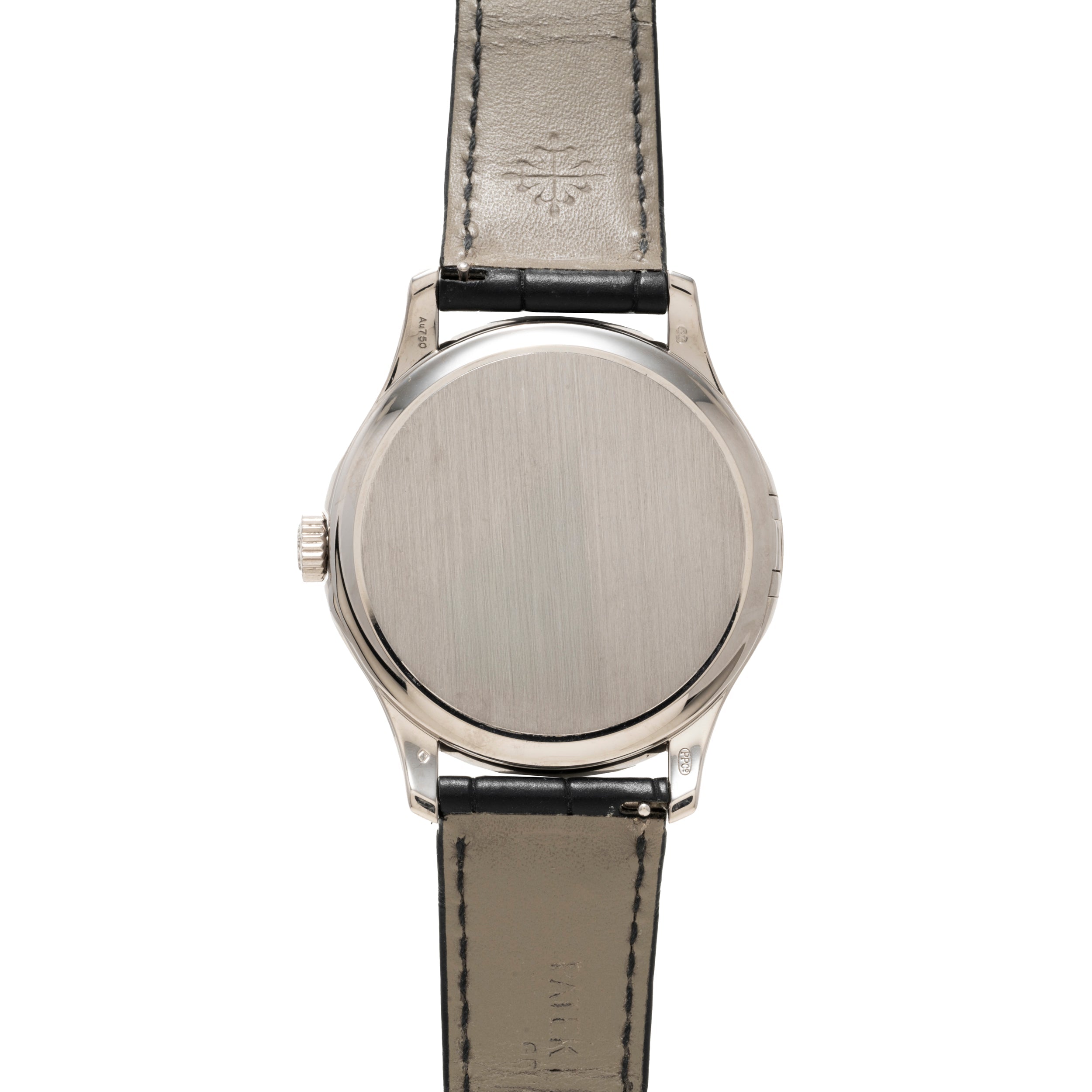 The back of a Patek Philippe Calatrava silver wristwatch with a black leather strap, showing a plain metal case back.