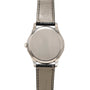 The back of a Patek Philippe Calatrava silver wristwatch with a black leather strap, showing a plain metal case back.
