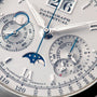 Close-up of the Lange & Sohne Datograph Perpetual Calendar watch face featuring multiple dials, blue and silver hands, and a moon phase display.