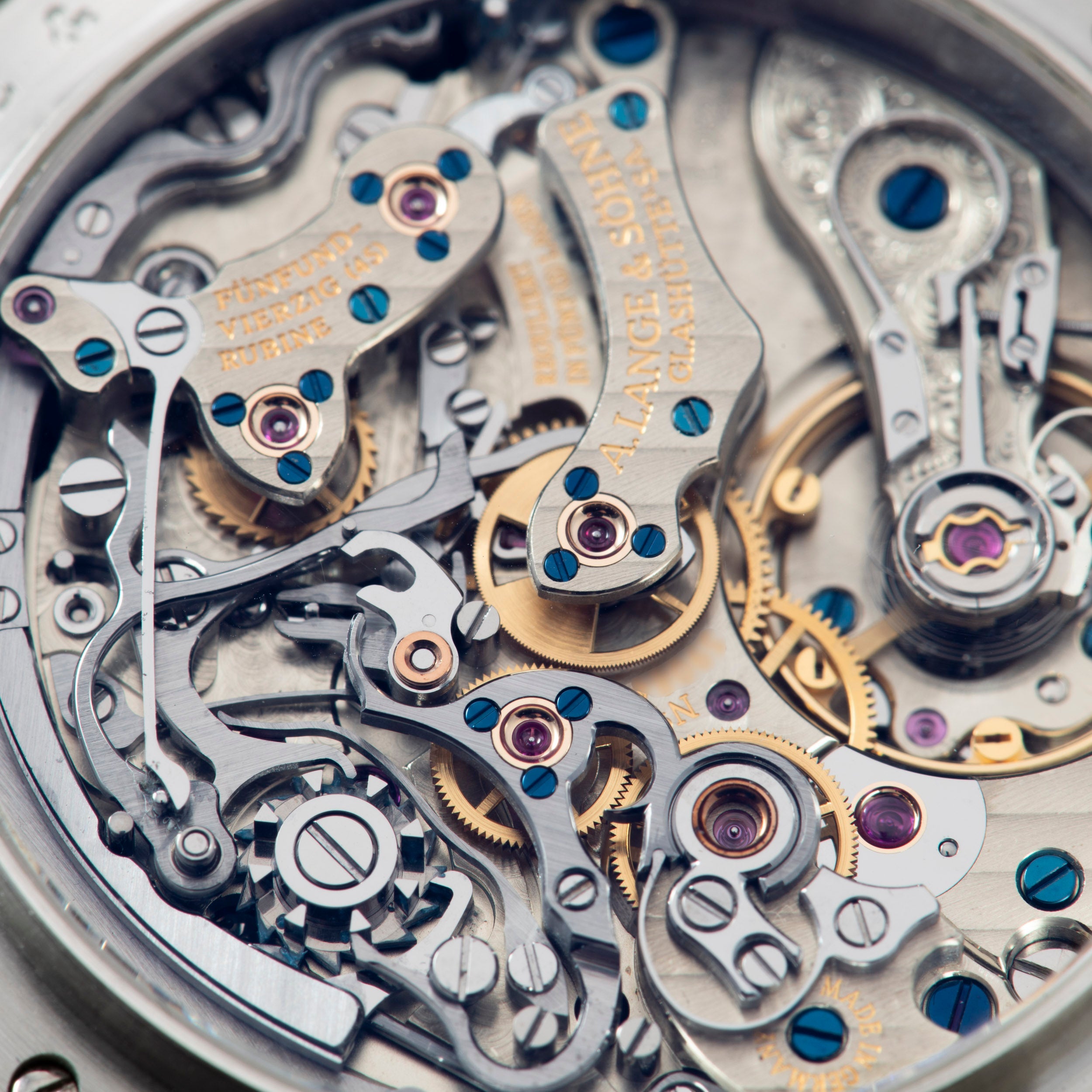 Close-up of the intricate gears and mechanisms inside the Lange & Sohne Datograph Perpetual Calendar luxury mechanical timepiece.