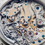 Close-up of the intricate gears and mechanisms inside the Lange & Sohne Datograph Perpetual Calendar luxury mechanical timepiece.
