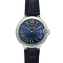 The Cartier Ballon Bleu is a silver watch featuring a blue dial, Roman numerals, and a black leather strap.