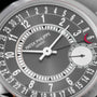 Close-up of a Patek Philippe Calatrava watch face featuring date numbers, hands, and a small seconds subdial.