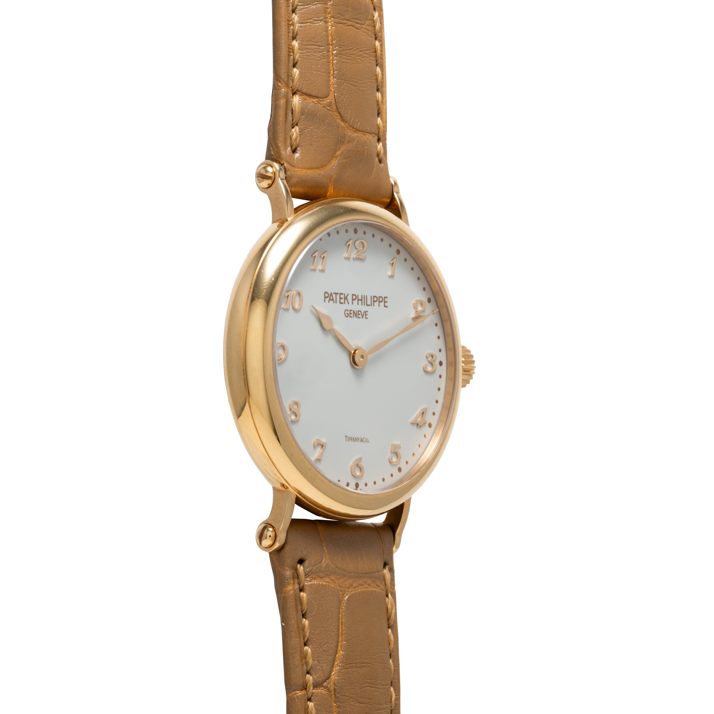 Patek Philippe Calatrava gold wristwatch with a brown leather strap and white dial, shown at an angle.