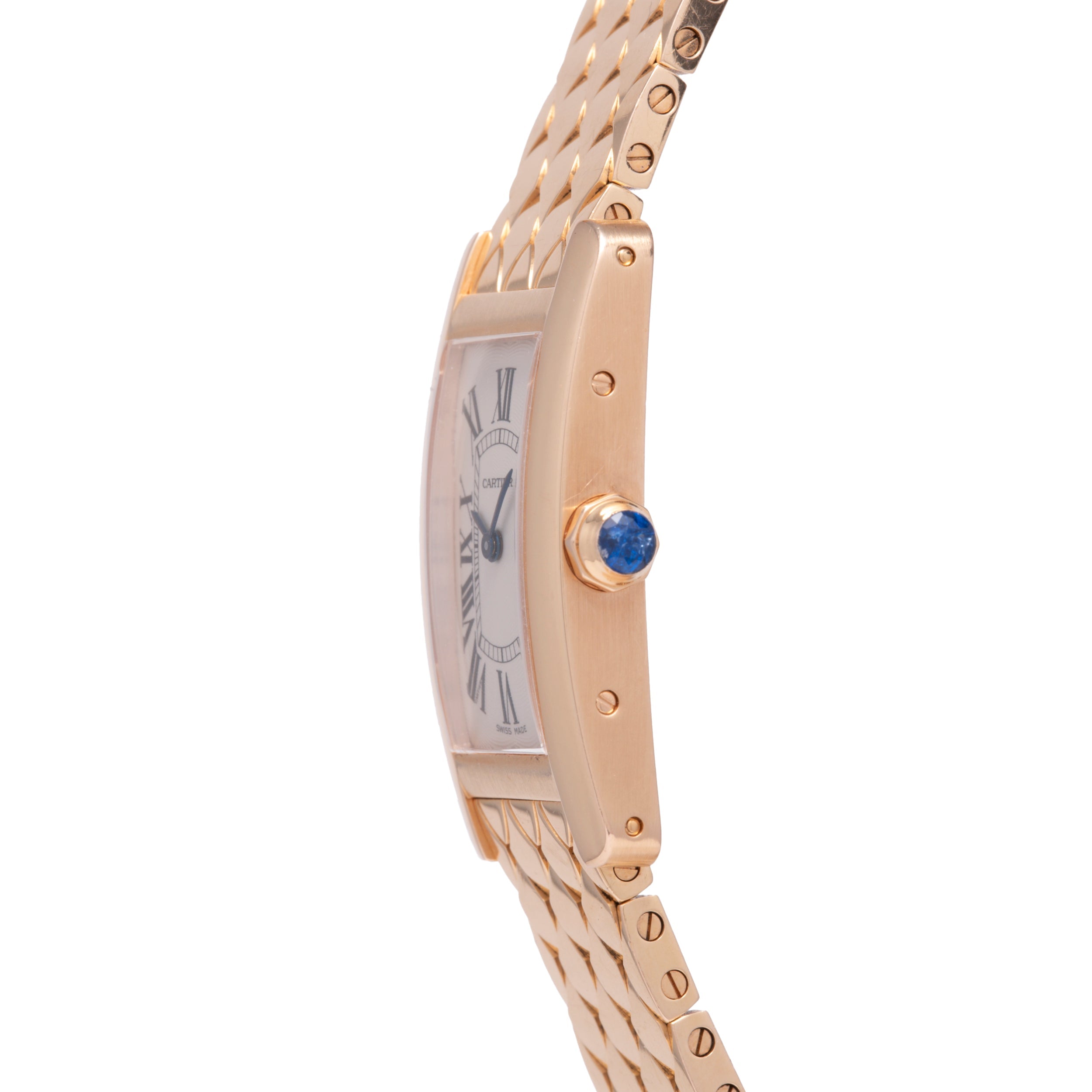 A close-up side view of the Cartier Tank Americaine by Cartier, a ladies’ 18K rose gold watch featuring a silver guilloché dial with Roman numerals, blue gemstone crown, and gold link bracelet.