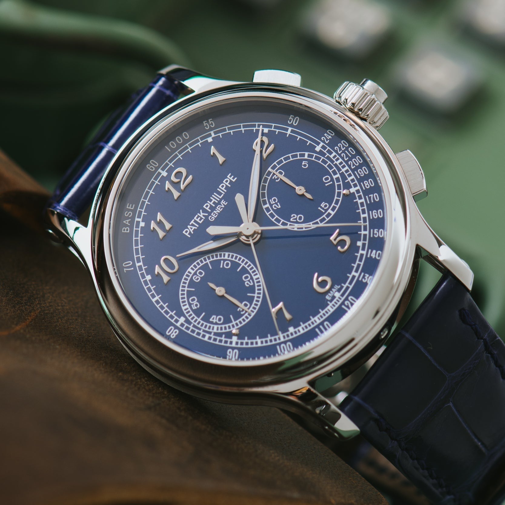 A close-up of a Patek Philippe Split-Seconds Chronograph wristwatch featuring a blue face and leather strap.