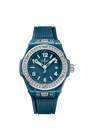Petrol blue ceramic women's watch with diamond-set bezel, white numerals, and ribbed rubber strap.