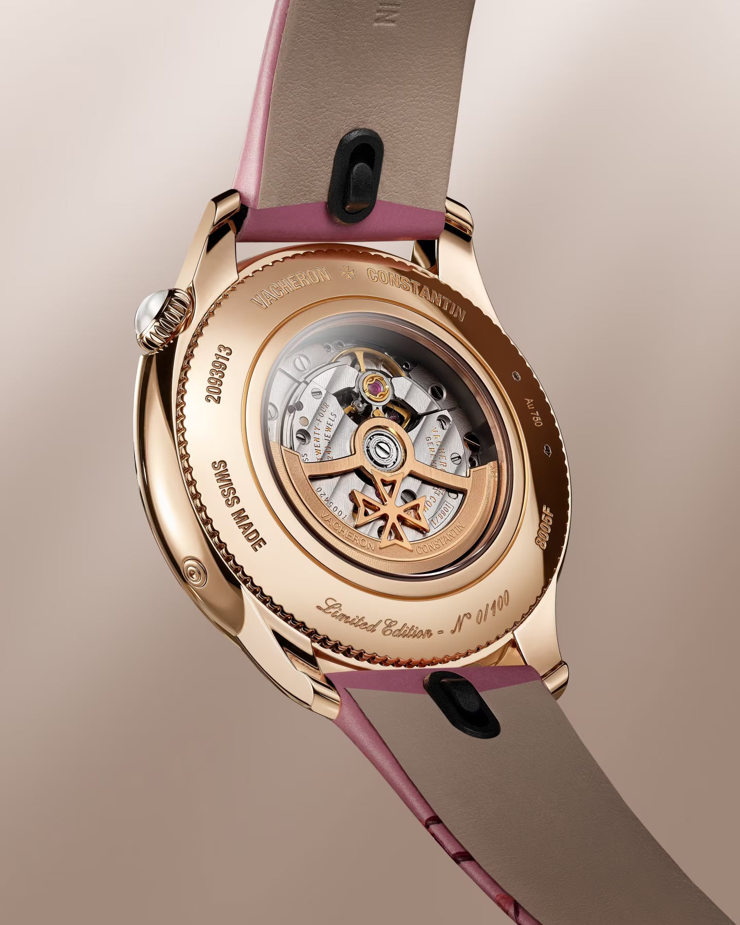 Rose gold watch with visible skeleton back displaying mechanical movement, purple and taupe leather strap with black accents.