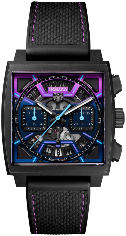 The TAG Heuer Monaco Chronograph Las Vegas Edition features a square titanium DLC-coated case, purple and blue accents, exposed movement, two subdials, and a black textured strap with bold purple stitching.