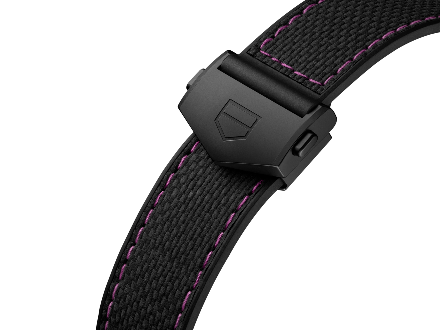 A close-up of the TAG Heuer Monaco Chronograph Las Vegas Edition's black fabric strap with purple stitching and a matte black clasp engraved with a geometric logo, inspired by its titanium DLC-coated case.