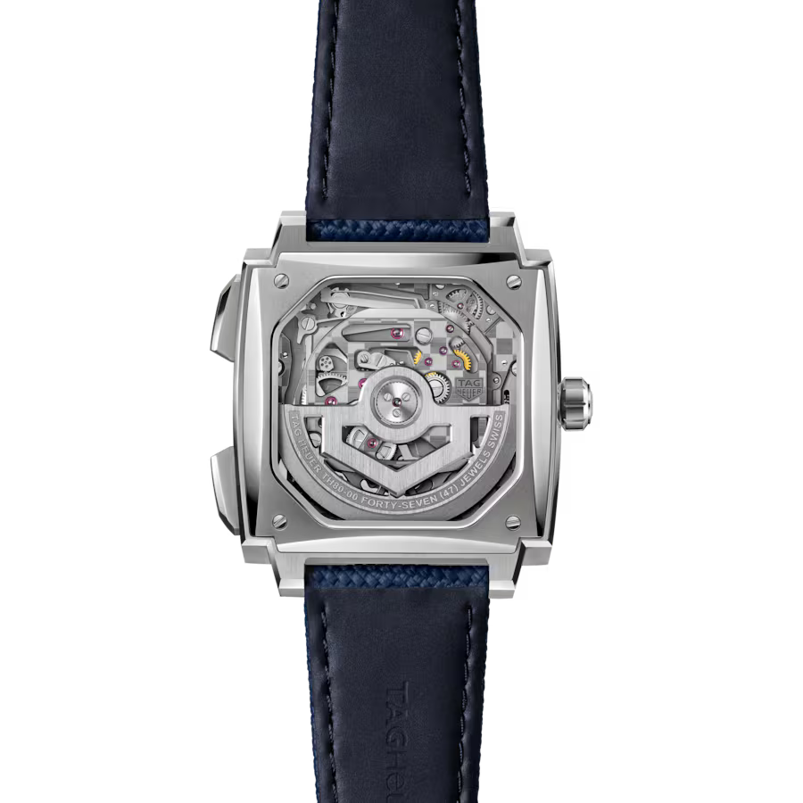 Square stainless steel watch with exposed mechanical movement visible through clear case back, dark blue leather strap.