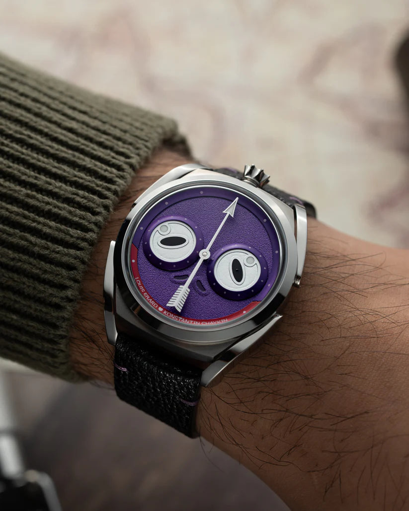 Watch with a purple face on a wrist against a blurred background