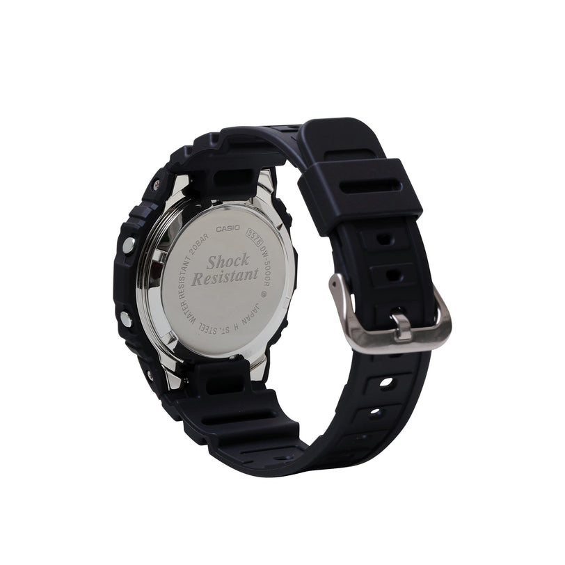 Digital watch with stainless steel case back, black resin band, and silver buckle displayed from rear angle.