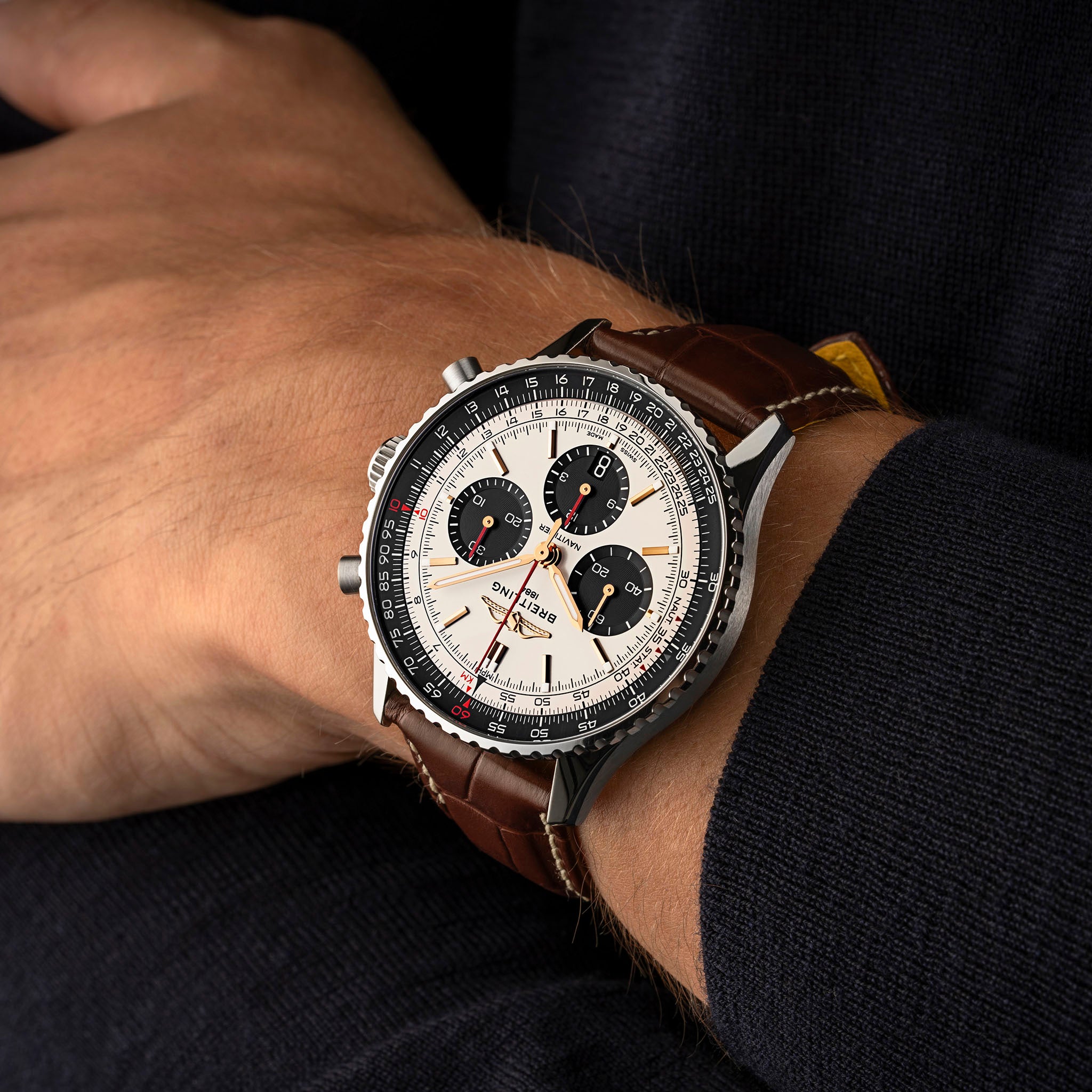 Close-up of a wrist wearing a detailed wristwatch with a brown leather strap.