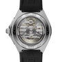 Silver-tone watch with black rubber strap displaying exposed automatic movement through transparent caseback with gold accent