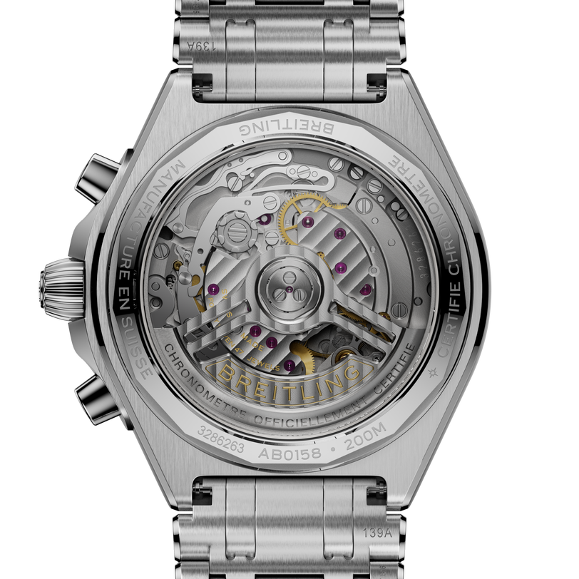Chronomat B01 42 stainless steel watch with visible mechanical movement, exposed caseback, and integrated metal bracelet.