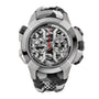 Steel chronograph watch with skeletal dial, visible automatic movement, two subdials, red hands, and black rubber strap.