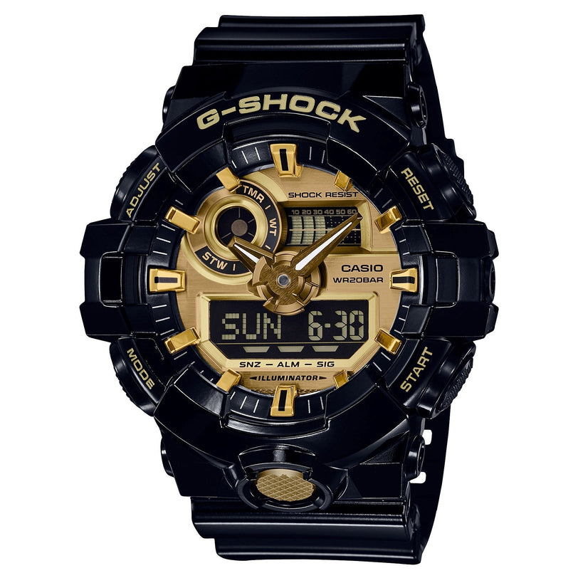 Black G-Shock digital watch with gold-tone dial, analog hands, LCD display, and resin band.