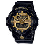 Black G-Shock digital watch with gold-tone dial, analog hands, LCD display, and resin band.