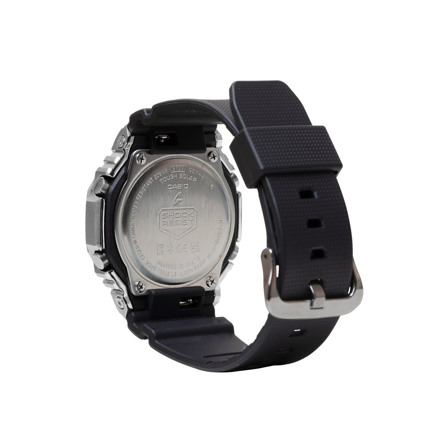 Digital watch with stainless steel case, black resin band, and engraved silver caseback displaying Casio G-Shock branding.