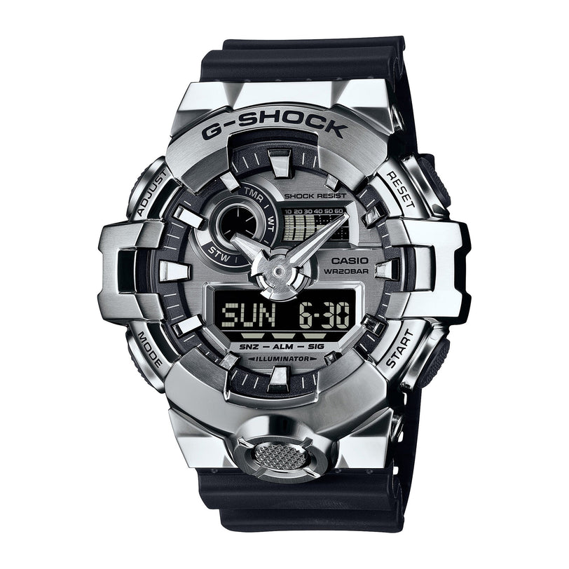 G-Shock digital watch with silver stainless steel case, black resin band, analog and digital display showing time and day.