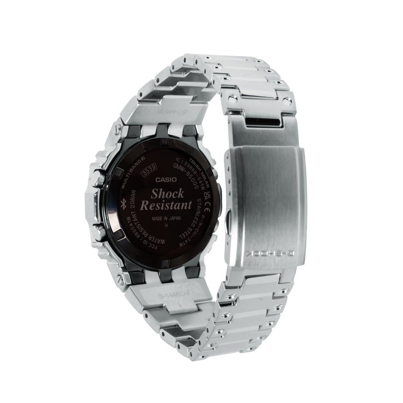 Silver stainless steel digital watch with black dial, square face, and metal link band shown from back view.