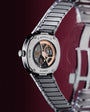 H. Moser & Cie stainless steel watch with black link bracelet and exposed skeleton dial showing rose gold and black mechanism