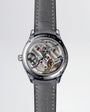 Stainless steel skeleton watch with visible tourbillon, ruby jewels, and H. Moser & Cie branding on gray leather strap.