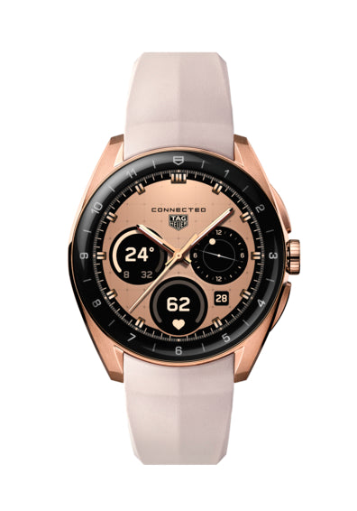 The TAG Heuer Connected Calibre E5 40mm is a luxury smartwatch with a rose gold case, beige dial, black bezel, digital display, and light beige rubber strap. It shows time, date, and fitness metrics on its watch face.