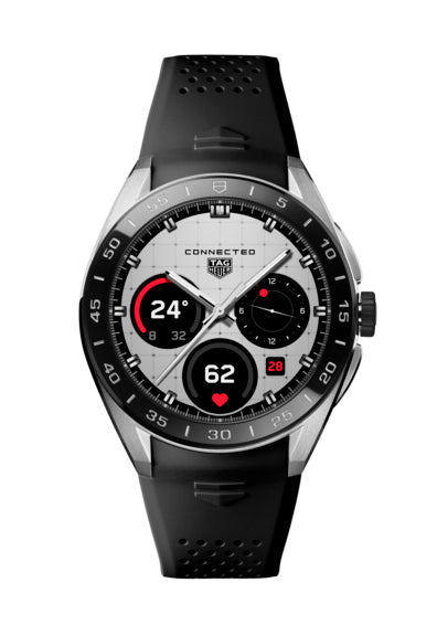 The TAG Heuer Connected Calibre E5 45mm is a luxury smartwatch with a black rubber strap and silver digital face displaying time, date, heart rate, temperature, and step count.