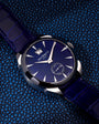 Jacob & Co watch with dark blue dial, silver hour markers, and matching blue crocodile leather strap.