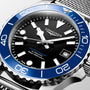 Longines watch with blue bezel and black dial on a light gray background