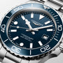 Longines watch with blue dial and silver case on a light gray background