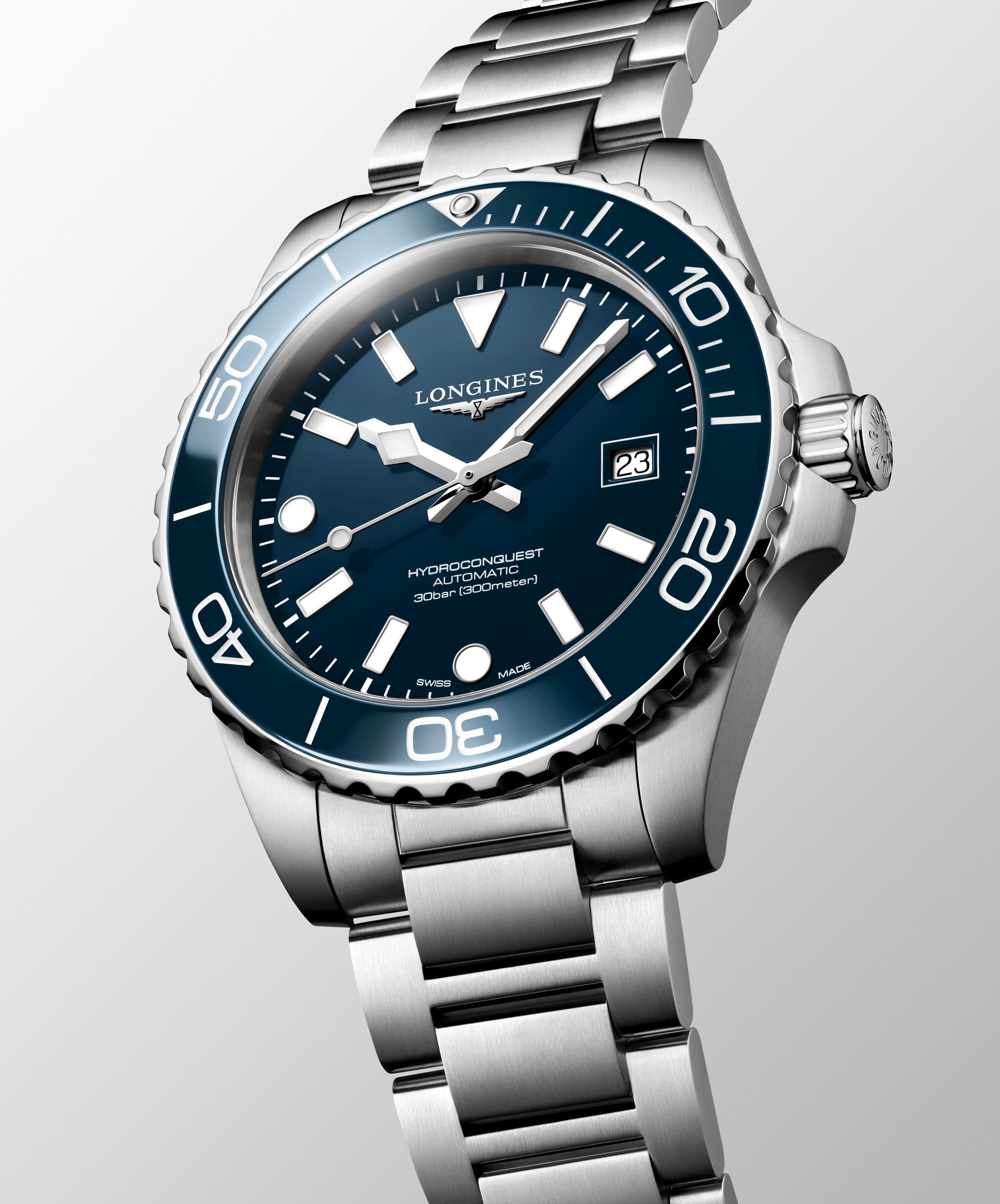 Longines watch with blue dial and silver bracelet on a light gray background