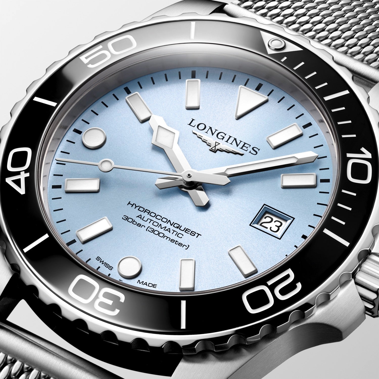 Longines watch with silver case and blue dial on a white background